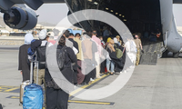 Evacuees prepare to board a C-17 Globemaster III at Hamid Karzai International Airport, Afghanistan, Aug. 18, 2021