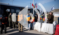 Displaced Ukrainians who have just crossed the Medyka border in Poland getting assistance from IOM